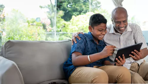 Child and parent whatching a tablet